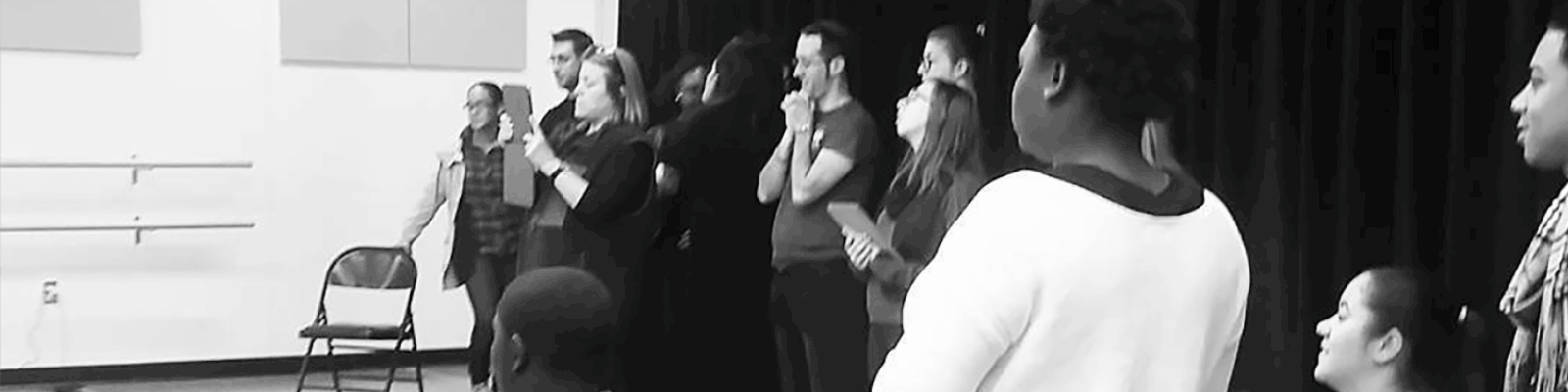 A group gathered in a rehearsal room